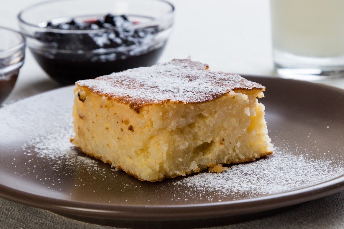 Ein Stück Reiskuchen, im Hintergrund ein Schälchen Fruchtkompott.