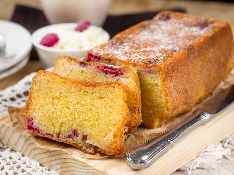 Ein angeschnittener Himbeer-Ricotta-Kuchen.