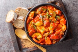 Vegetarisches Güvec in einem Topf mit Brot.