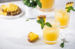 Drei Gläser Ananas-Fizz auf einem Tisch