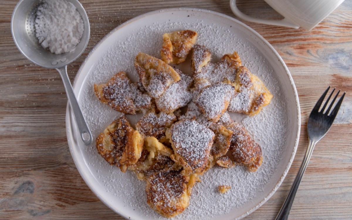 Kaiserschmarrn aus dem Airfryer mit Puderzucker auf einem Teller.