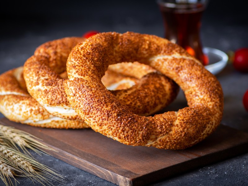 Ein paar türkische Sesamkringel namens Simit auf einem Brett.