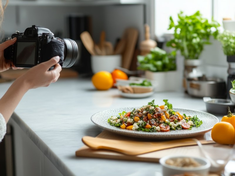 Frau fotografiert selbst zubereitetes Essen